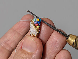 a small tube of beads being crocheted